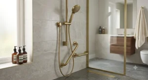 Premium brushed brass handheld shower head with long hose inside a luxury British wetroom installation