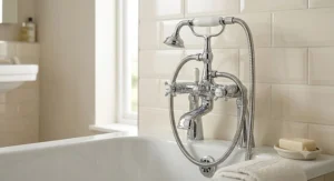 Detachable handheld shower head with long hose connected to a traditional mixer bath tap