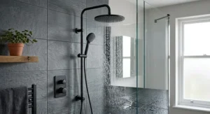 Contemporary matte black dual shower head system mounted in a minimalist British wetroom.