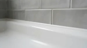 Close-up of an offset quadrant shower tray for small bathroom fitted neatly against tiled walls