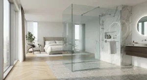 Open-plan master bedroom ensuite featuring a seamless frameless shower enclosure design