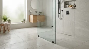 A tileable shower tray for wet room installation finished with matching large format slate grey tiles.